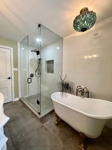 a bathroom with a claw foot tub and a glass shower