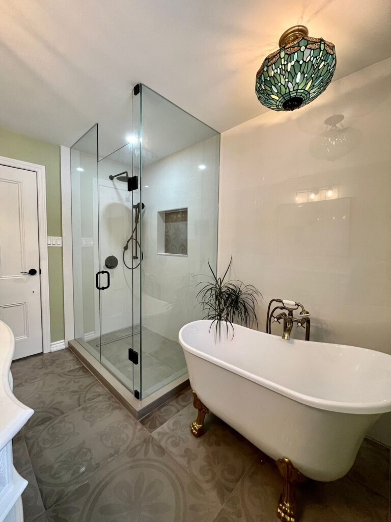 a bathroom with a claw foot tub and a glass shower