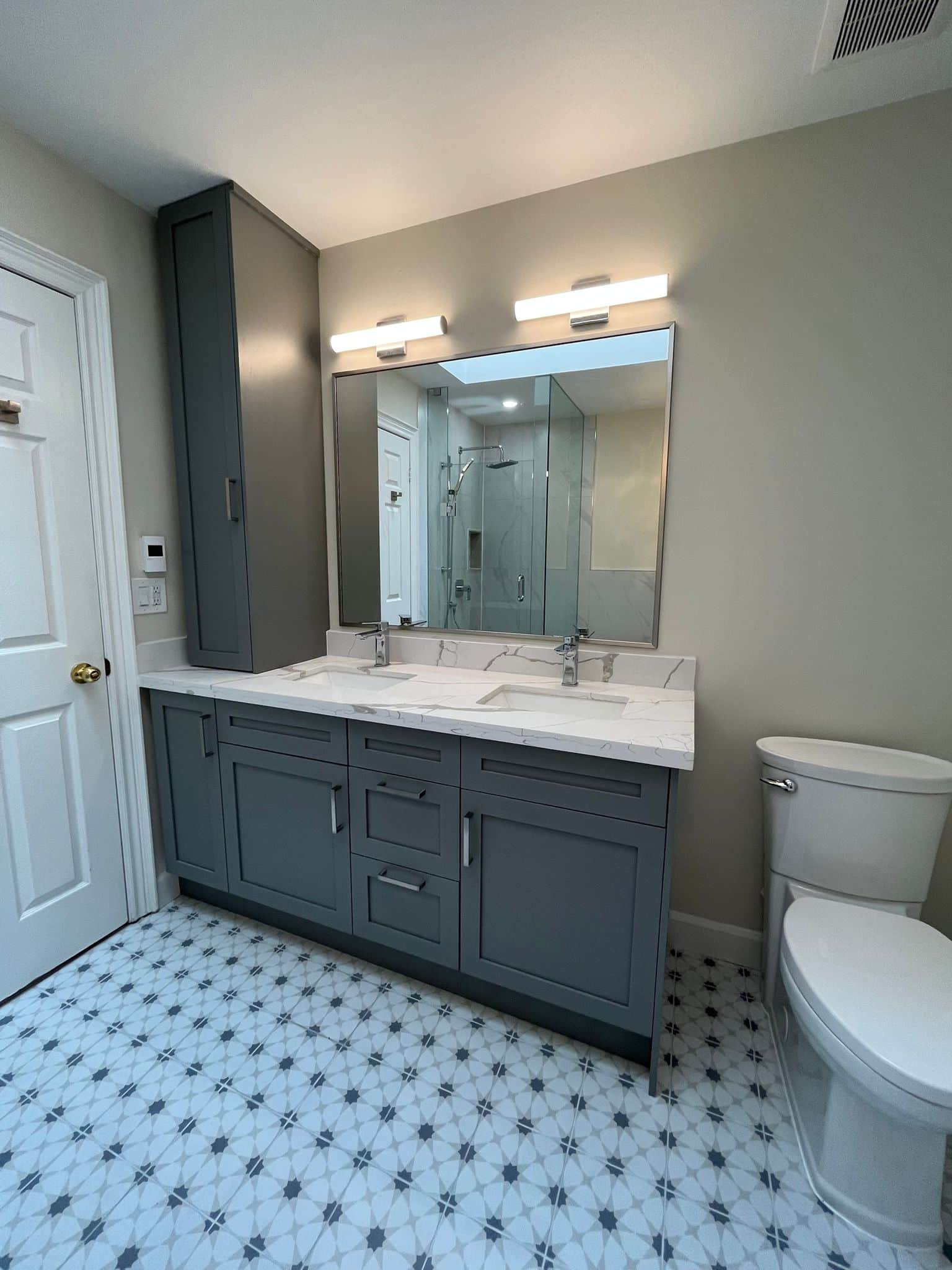 Grey custom vanity with with white quartz countertop