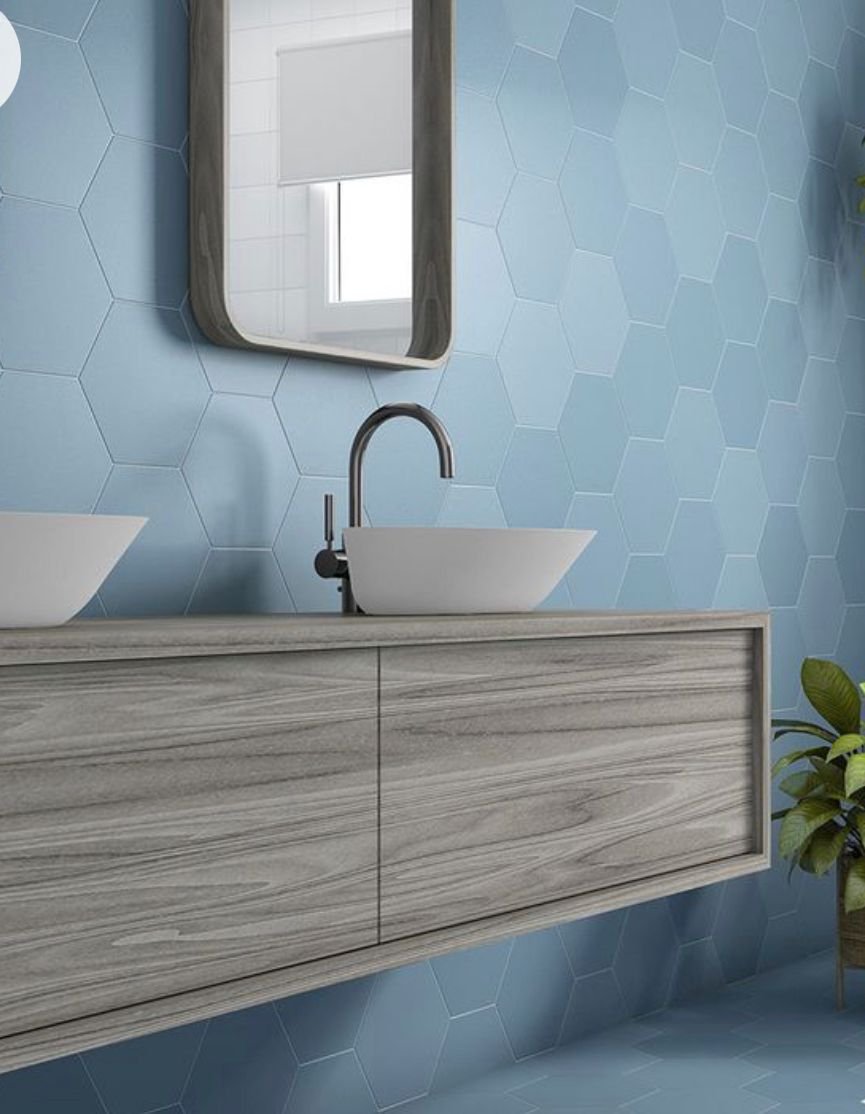 Wood floating vanity with vessel sinks and blue hexagon tile