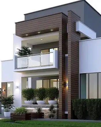 Modern two-story house exterior with a contemporary design featuring large windows, a balcony with glass railings, and wood panel accents. The facade includes lush landscaping with potted plants and well-manicured shrubs. The home has a sleek, minimalist aesthetic, highlighted by clean lines and a combination of white and wooden finishes.