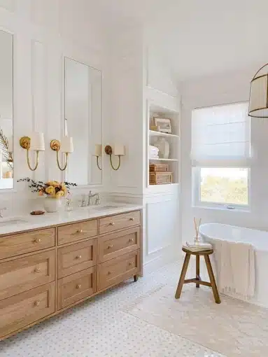 a white bathroom with a tub, sink, and mirror