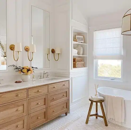 a white bathroom with a tub, sink, and mirror