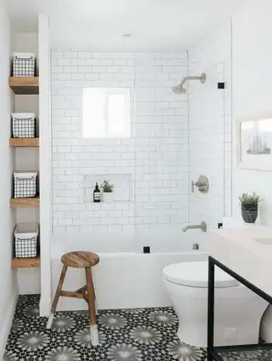 a white bathroom with a black and white tile floor