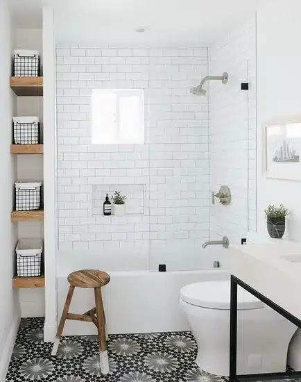 a white bathroom with a black and white tile floor