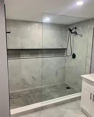a bathroom with a walk in shower next to a sink