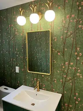 a bathroom with a toilet, sink and mirror