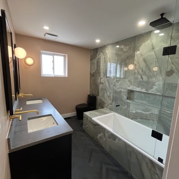 Luxurious bathroom with herringbone tiles and a custom glass shower
