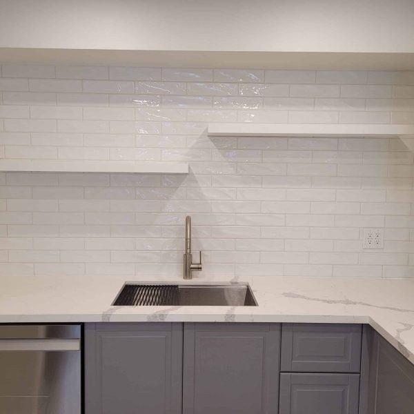 Charming kitchen renovation with rustic wooden cabinets, a cozy breakfast nook, and classic tile backsplash.