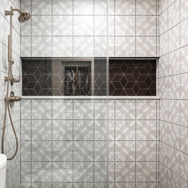 Small bathroom renovation with white panel tiles and gold shower fixtures