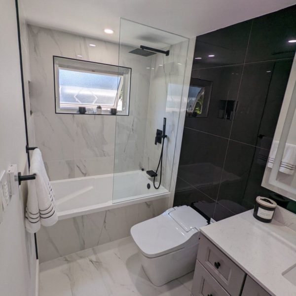 Drop in bathtub with smart toilet and rainfall shower fixture