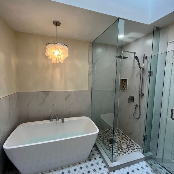 Freestanding tub and glass shower under a skylight
