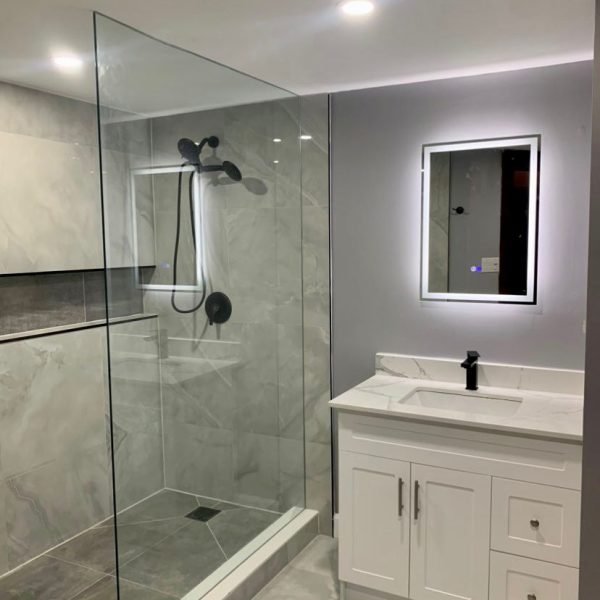 walk in shower with white vanity and LED vanity mirror