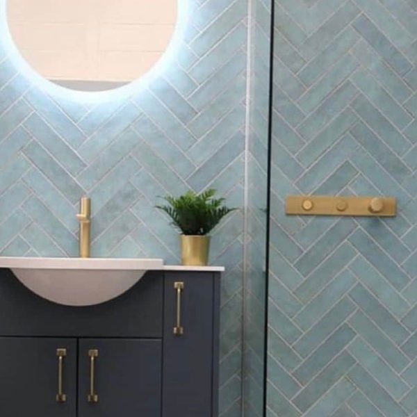 Blue herringbone tiles and navy blue 24 inch vanity