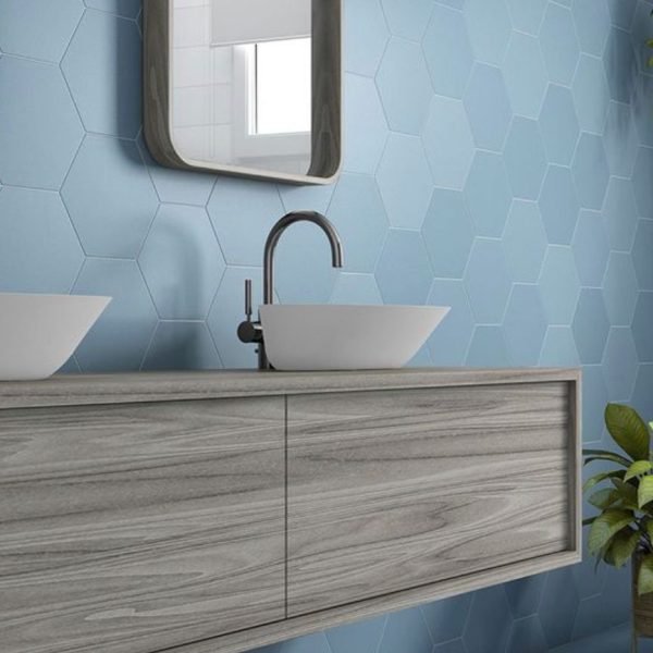 Wood floating vanity with vessel sinks and blue hexagon tile