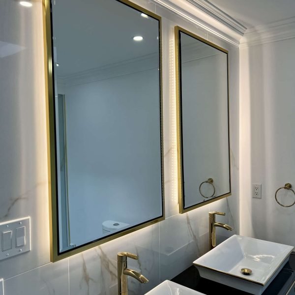 Led golden framed mirror with marble back tile wall