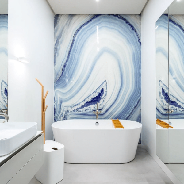 a bath room with a bath tub a sink and a mirror